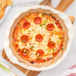 dip cooked in white baking dish topped with pepperoni.