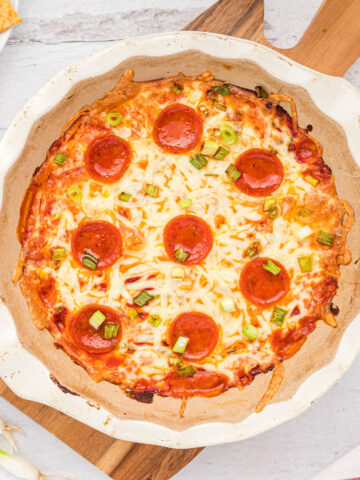 dip cooked in white baking dish topped with pepperoni.