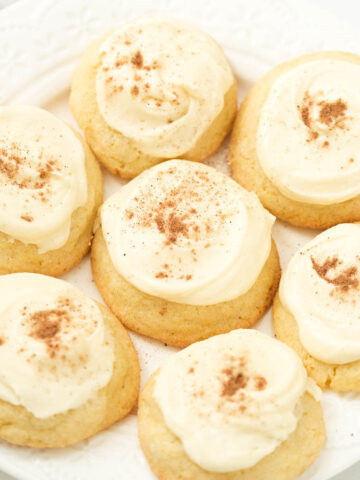 soft eggnog cookies on white plate.