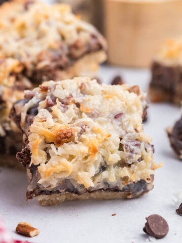 magic bars on white back ground with coconut and chocolate chips.