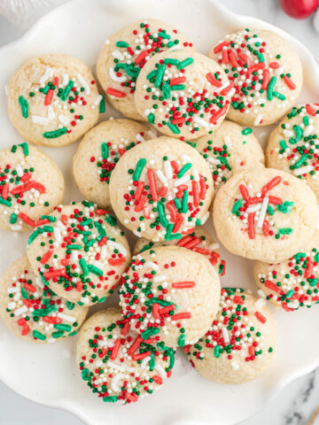 Christmas cookies on white plate.