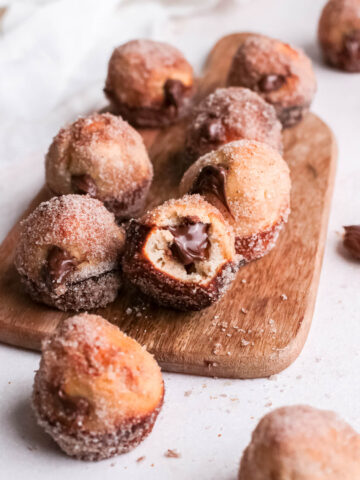 Close-up of Nutella donut hole with bite take out of center.