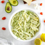 creamy avocado pasta in white bowl.