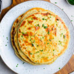 easy homemade flatbread on white plate topped with fresh parsley