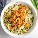 shrimp ramen salad in white bowl.