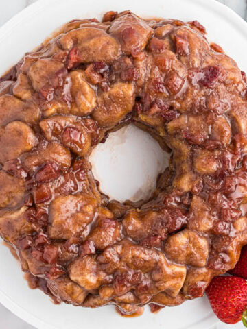 overhead view of strawberry monkey bread on white plate.